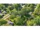 High aerial view of the property, surrounding mature trees, and neighboring community at 710 N Spring St, Greenfield, IN 46140