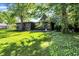 Lush backyard with a large tree and well-manicured lawn, providing a serene outdoor space at 710 N Spring St, Greenfield, IN 46140