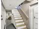 Basement staircase with white painted wood and access to storage and laundry at 710 N Spring St, Greenfield, IN 46140