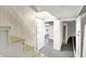 Basement hallway featuring white doors and access to unfinished storage at 710 N Spring St, Greenfield, IN 46140