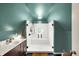 This bathroom showcases a new walk-in shower with a clear glass door, vanity and a window at 710 N Spring St, Greenfield, IN 46140