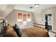 Bedroom featuring neutral walls, a bed with bronze bedding and views into the adjoining bathroom at 710 N Spring St, Greenfield, IN 46140