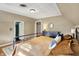 Spacious bedroom featuring neutral walls, a bed with bronze bedding and views into other rooms at 710 N Spring St, Greenfield, IN 46140