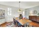 Traditional dining room featuring a wood table, colorful rug, and vintage furnishings at 710 N Spring St, Greenfield, IN 46140