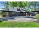 Charming home featuring a brick porch, three-car garage, and an expansive paved driveway at 710 N Spring St, Greenfield, IN 46140