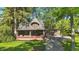 Charming home featuring a covered porch with brick accents and attached two-car garage at 710 N Spring St, Greenfield, IN 46140