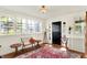 Bright foyer featuring hardwood floors, large windows, and a charming seating arrangement at 710 N Spring St, Greenfield, IN 46140