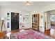 Elegant foyer showcasing hardwood floors, a vintage cabinet, and bright, natural light at 710 N Spring St, Greenfield, IN 46140