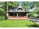 Charming craftsman-style home with a large front porch, updated brickwork, and lush lawn at 710 N Spring St, Greenfield, IN 46140