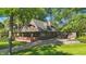 Beautiful home with a brick porch, balcony, dormer window, and lush landscaping at 710 N Spring St, Greenfield, IN 46140