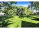 Lush green front lawn framed by mature trees, offering ample space and shade at 710 N Spring St, Greenfield, IN 46140