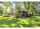 Well-manicured front yard featuring a home with a covered porch, mature trees and greenery at 710 N Spring St, Greenfield, IN 46140