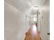 Hallway with hardwood floors and fresh, white trim that leads to all the upper level living spaces at 710 N Spring St, Greenfield, IN 46140