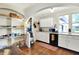 Classic kitchen featuring white cabinets, hardwood floors, and open shelving above countertop at 710 N Spring St, Greenfield, IN 46140