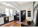 Classic kitchen with white and black appliances, arched opening, and hardwood floors at 710 N Spring St, Greenfield, IN 46140