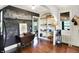 Bright kitchen with a drop leaf table, chalkboard wall, white shelves, and hardwood floors at 710 N Spring St, Greenfield, IN 46140