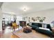 Large living room with dark green sofa, assorted chairs and decor at 710 N Spring St, Greenfield, IN 46140