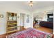 Spacious living room showcasing hardwood floors, a vintage display cabinet, and an open layout at 710 N Spring St, Greenfield, IN 46140