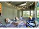 Cozy sunroom featuring lots of natural light, string lights, and comfortable seating at 710 N Spring St, Greenfield, IN 46140