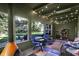 Inviting sunroom with an orange fireplace, charming string lights and a view of the home's spacious outdoor area at 710 N Spring St, Greenfield, IN 46140