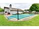 Backyard patio with covered pool, red lawn chairs and attached house at 73 Suncrest Dr, Greenwood, IN 46143