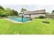 A fenced backyard features a covered in-ground pool, fire pit, and manicured lawn at 73 Suncrest Dr, Greenwood, IN 46143