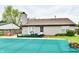 Covered in-ground pool, deck with outdoor seating and view of the home's exterior at 73 Suncrest Dr, Greenwood, IN 46143