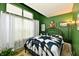 Well-lit bedroom featuring a striking green wall and large window at 73 Suncrest Dr, Greenwood, IN 46143