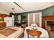 Dining area features a fireplace, adjacent to kitchen with exterior access at 73 Suncrest Dr, Greenwood, IN 46143