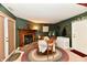 Cozy dining area with fireplace, round table, and chairs on a decorative rug at 73 Suncrest Dr, Greenwood, IN 46143