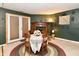 Dining area with fireplace, round table, and chairs featuring a decorative rug at 73 Suncrest Dr, Greenwood, IN 46143