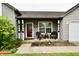 Cozy front porch of this charming home with outdoor furniture and decorative wreath at 73 Suncrest Dr, Greenwood, IN 46143