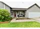 Inviting porch with chairs and a table, complemented by a wreath on the front door at 73 Suncrest Dr, Greenwood, IN 46143