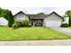 Charming single-story home with manicured lawn, covered porch, and attached two-car garage at 73 Suncrest Dr, Greenwood, IN 46143