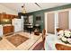 Eat-in kitchen features wood cabinetry, black appliances, and neutral countertops at 73 Suncrest Dr, Greenwood, IN 46143