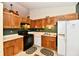 Kitchen boasts wood cabinetry, black appliances, and neutral countertops at 73 Suncrest Dr, Greenwood, IN 46143