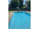 A clear blue in-ground swimming pool with metal ladder in a fenced backyard at 73 Suncrest Dr, Greenwood, IN 46143