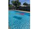 A pristine in-ground swimming pool with an inflatable raft in a fenced backyard at 73 Suncrest Dr, Greenwood, IN 46143
