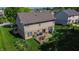 Spacious backyard with a patio seating area and lush green lawn, perfect for outdoor entertaining at 7322 Stones River Dr, Indianapolis, IN 46259