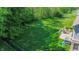Expansive green backyard with lush landscaping including a patio and outdoor seating area at 7322 Stones River Dr, Indianapolis, IN 46259