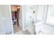 Bright bathroom featuring a glass shower, tub, and walk-in closet with ample storage space at 7322 Stones River Dr, Indianapolis, IN 46259