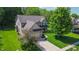 Gorgeous home with an attached two-car garage, and beautiful curb appeal, with lush green lawns and mature trees at 7322 Stones River Dr, Indianapolis, IN 46259