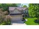 Beautiful two-story home featuring a two-car garage, well-manicured lawn, and lovely landscaping at 7322 Stones River Dr, Indianapolis, IN 46259
