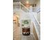 Inviting foyer featuring a staircase, decorative table with accents, and tile flooring, creating a warm welcome at 7322 Stones River Dr, Indianapolis, IN 46259
