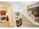 Inviting foyer with a staircase, neutral walls, and decorative accents create a warm and welcoming ambiance at 7322 Stones River Dr, Indianapolis, IN 46259