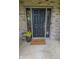 Welcoming front door with a personalized welcome mat and a potted plant, enhancing the entry's curb appeal at 7322 Stones River Dr, Indianapolis, IN 46259