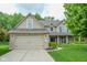 Charming two-story home features a brick-accented garage, manicured lawn, and welcoming curb appeal at 7322 Stones River Dr, Indianapolis, IN 46259