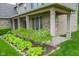 Inviting front porch area with brick columns, landscaping, and a hanging swing for relaxation at 7322 Stones River Dr, Indianapolis, IN 46259