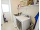 Bright laundry room featuring a washer, dryer, shelf, and supplies at 7322 Stones River Dr, Indianapolis, IN 46259
