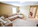 Cozy living room with large sectional and natural light at 7322 Stones River Dr, Indianapolis, IN 46259